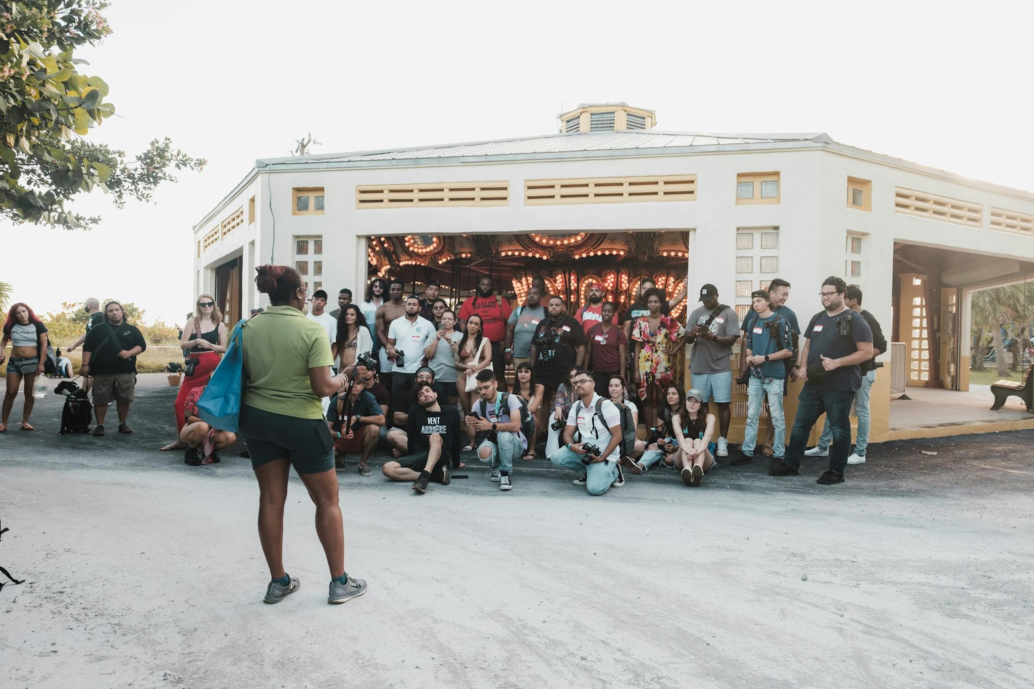 A diverse group of people attending an outdoor event at the University of Miami.
